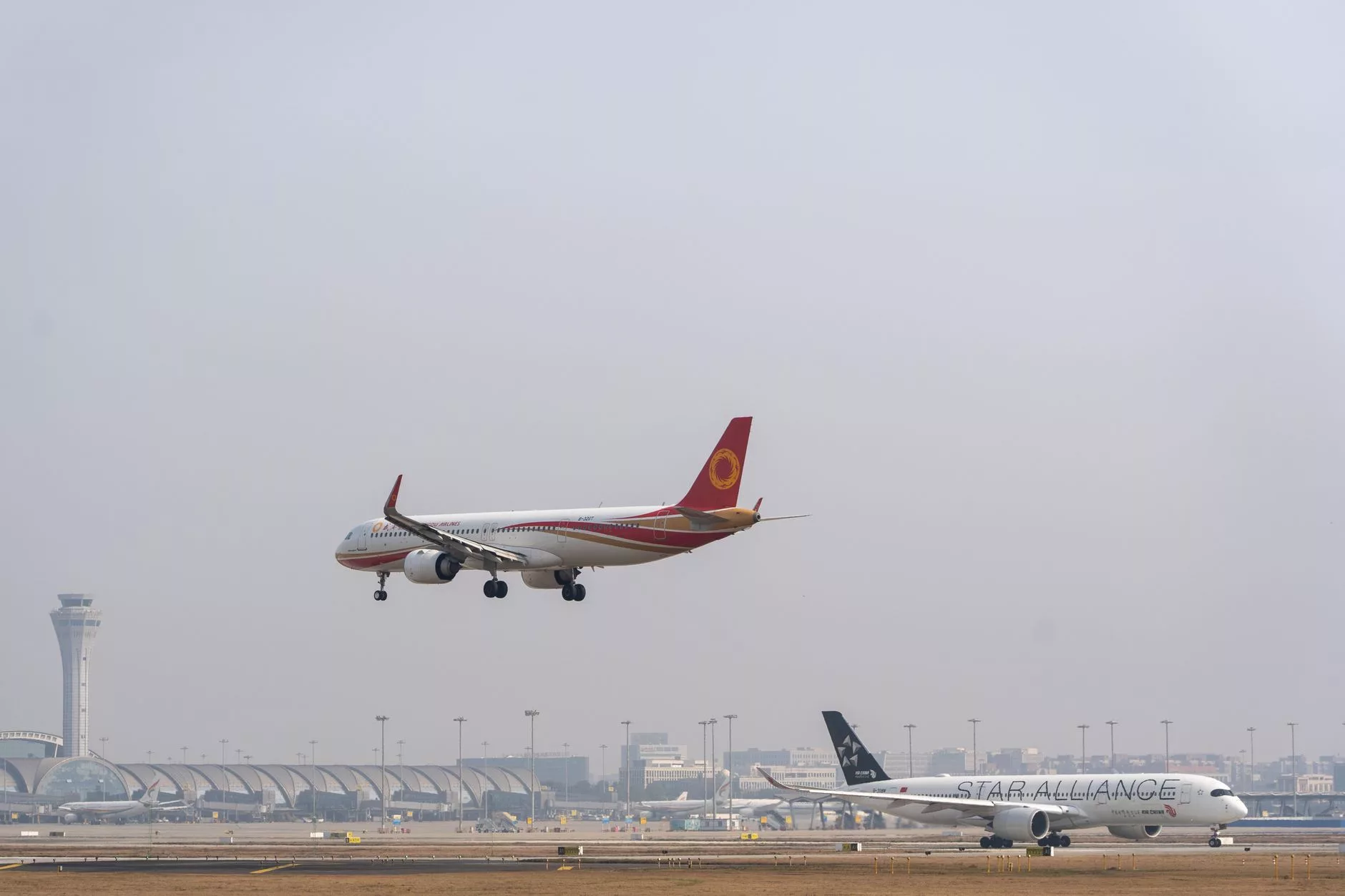 Dubai Uluslararası Havalimanı Terminal 3 önünde bekleyen modern kırmızı taksiler ve hareketli bir akşamüstü manzarası