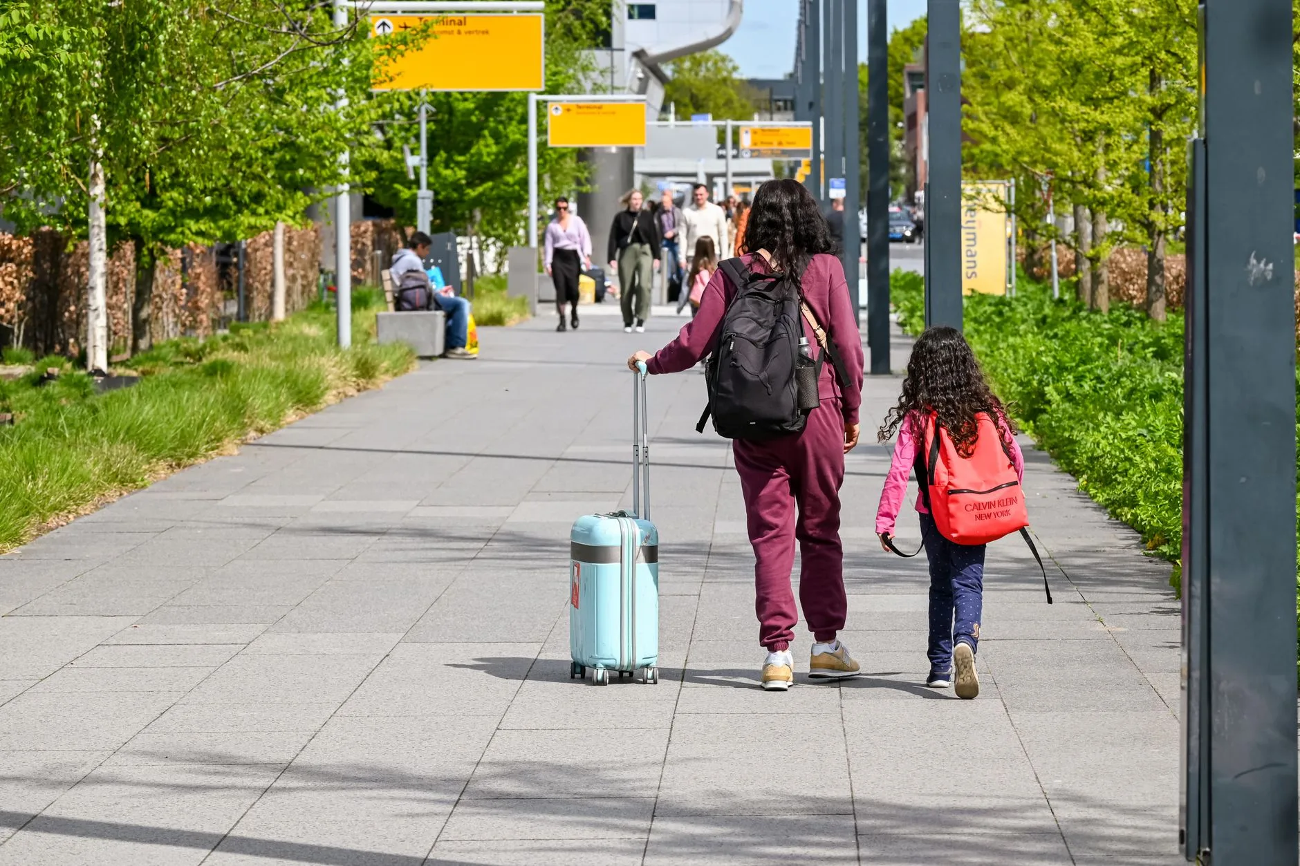 family walking airport terminal